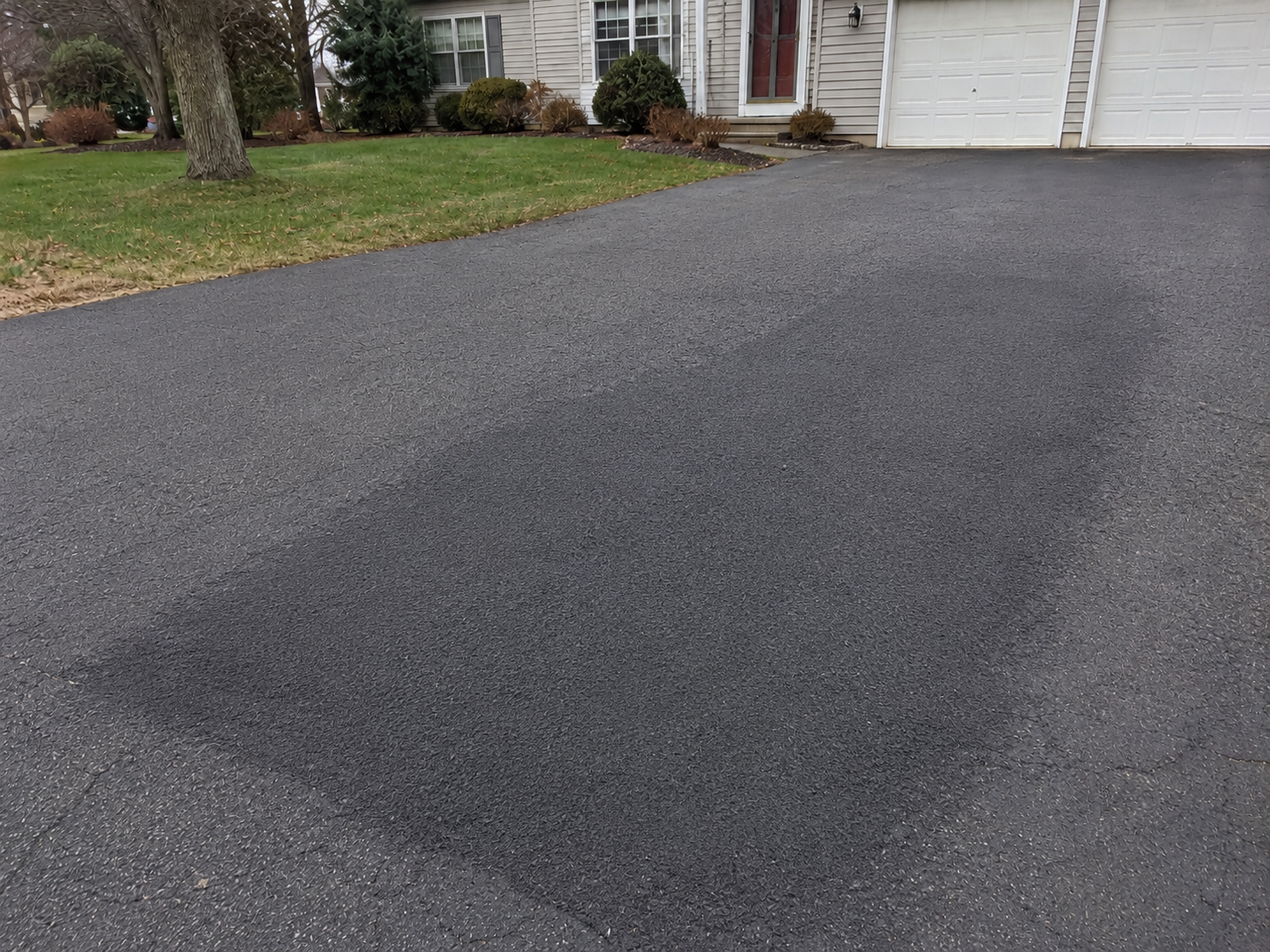 Asphalt driveway repair before and after transformation completed by MacDonald Contracting